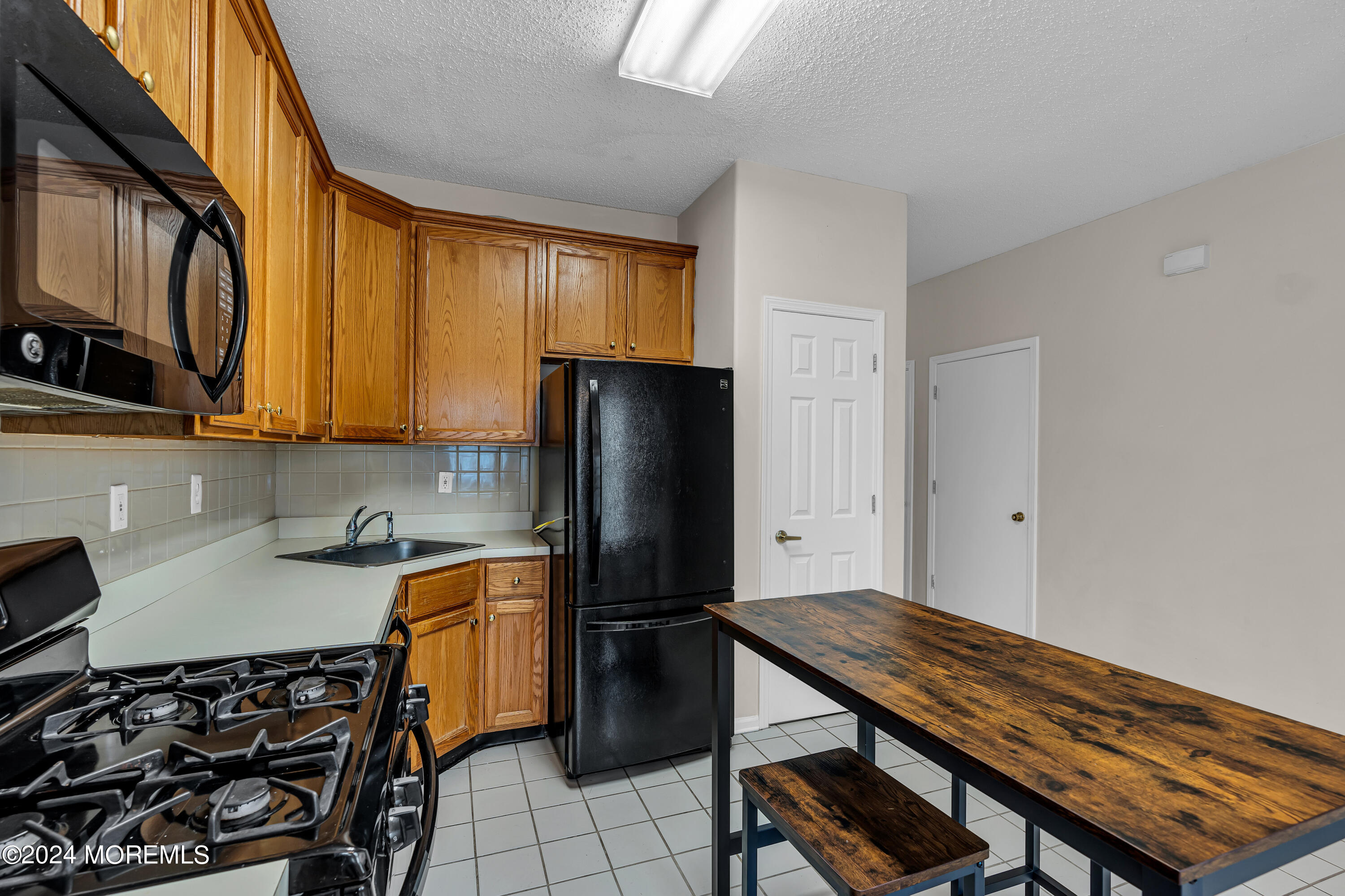 12 Riva Boulevard Brick, NJ 08723 - Photo 7 of 36 a kitchen with stainless steel appliances a stove a refrigerator and a sink