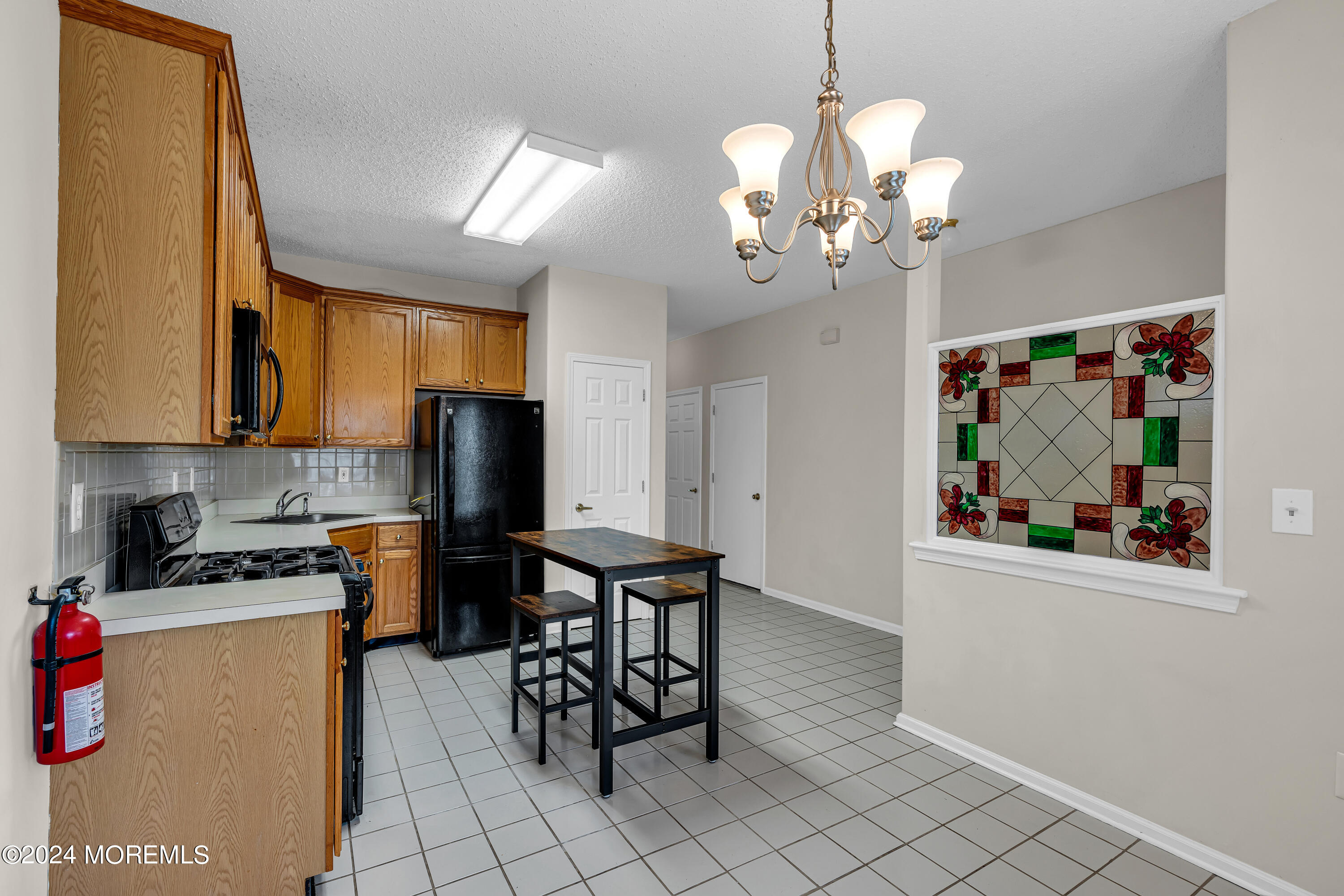 12 Riva Boulevard Brick, NJ 08723 - Photo 8 of 36 a view of a dining room with furniture and chandelier