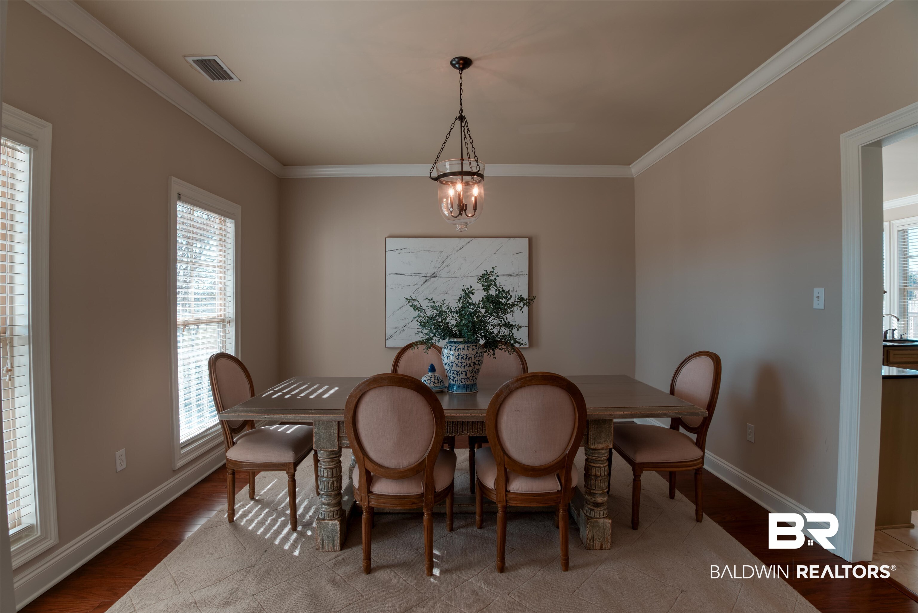 24561 Austin Road Daphne, AL 36526 - Photo 7 of 57 Dining room featuring hardwood / wood-style flooring, an inviting chandelier, and crown molding