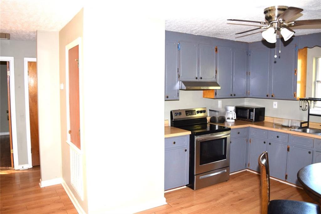 705 Triune Mill Road Thomaston, GA 30286 - Photo 11 of 34 a kitchen with stainless steel appliances granite countertop a sink a stove and cabinets