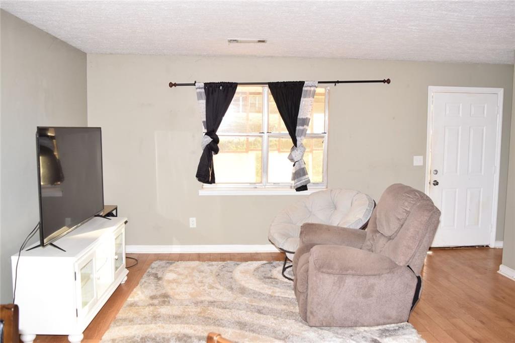 705 Triune Mill Road Thomaston, GA 30286 - Photo 13 of 34 a living room with furniture and a window