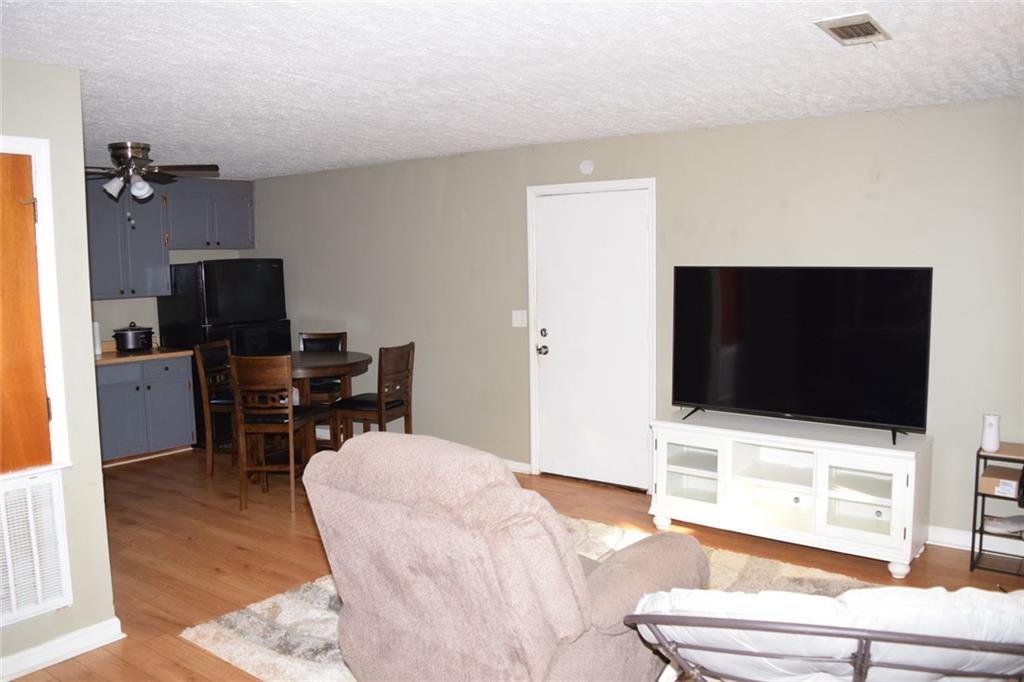 705 Triune Mill Road Thomaston, GA 30286 - Photo 17 of 34 a living room with furniture and a flat screen tv
