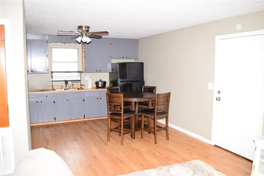 705 Triune Mill Road Thomaston, GA 30286 - Photo 8 of 34 a view of a kitchen with a dining table chairs and microwave