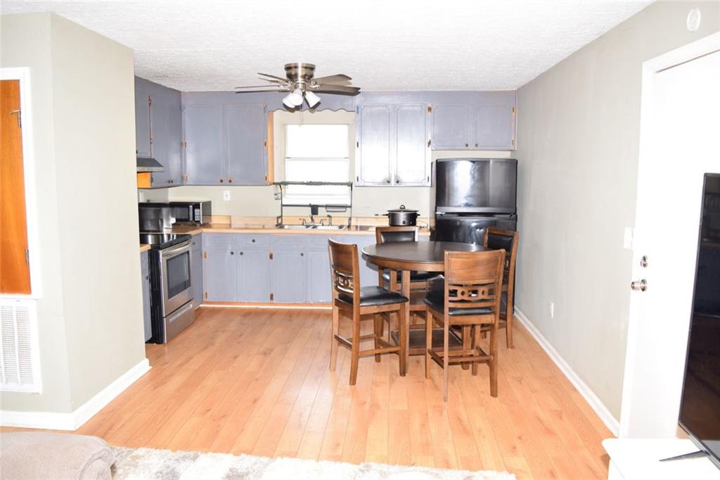 705 Triune Mill Road Thomaston, GA 30286 - Photo 10 of 34 a kitchen with a sink a window and stainless steel appliances
