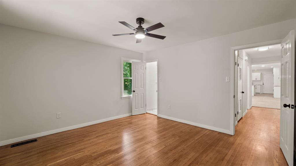 4600 Robinwood Drive Waco, TX 76708 - Photo 19 of 24 wooden floor in an empty room with a window