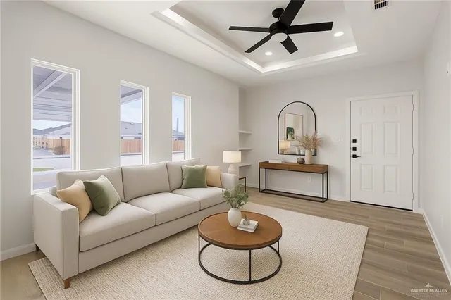a living room with furniture and a wooden floor