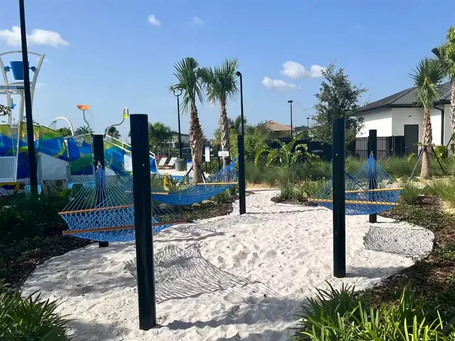 a living room with furniture and floor to ceiling windows