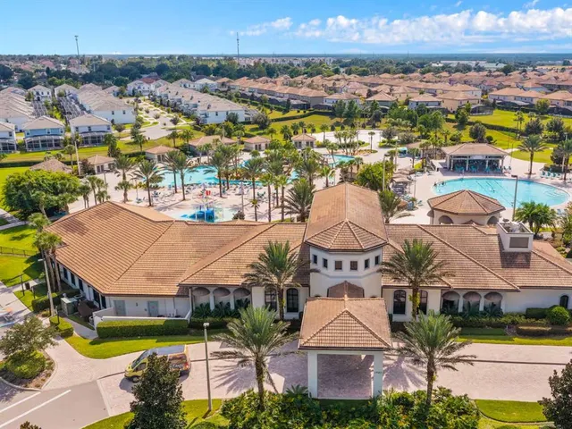 a room with pool table and windows