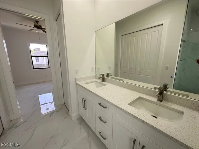 a bathroom with a double vanity sink and mirror
