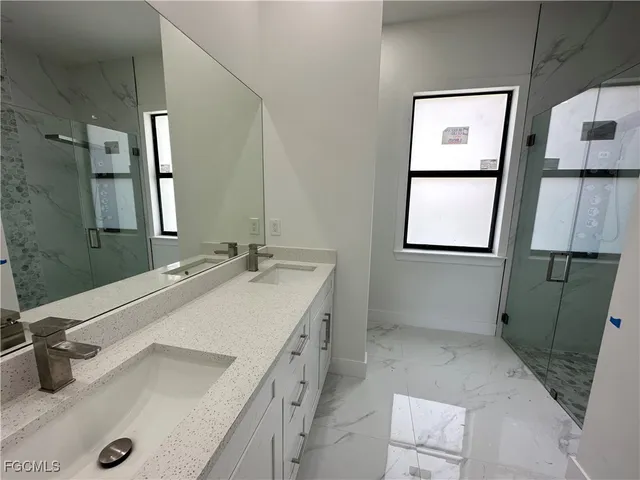 a bathroom with a sink and mirror with toilet