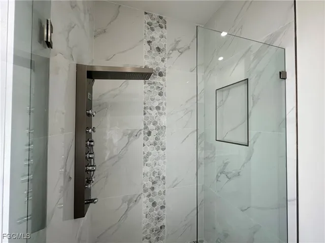 a bathroom with a shower and a mirror