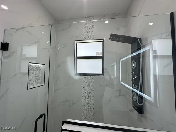 a bathroom with a shower and a shower