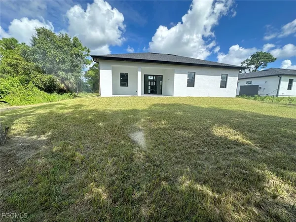 a front view of house with yard and trees