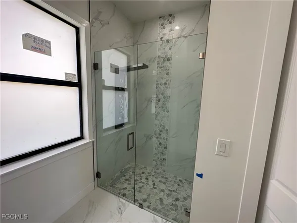 a bathroom with a shower and a mirror