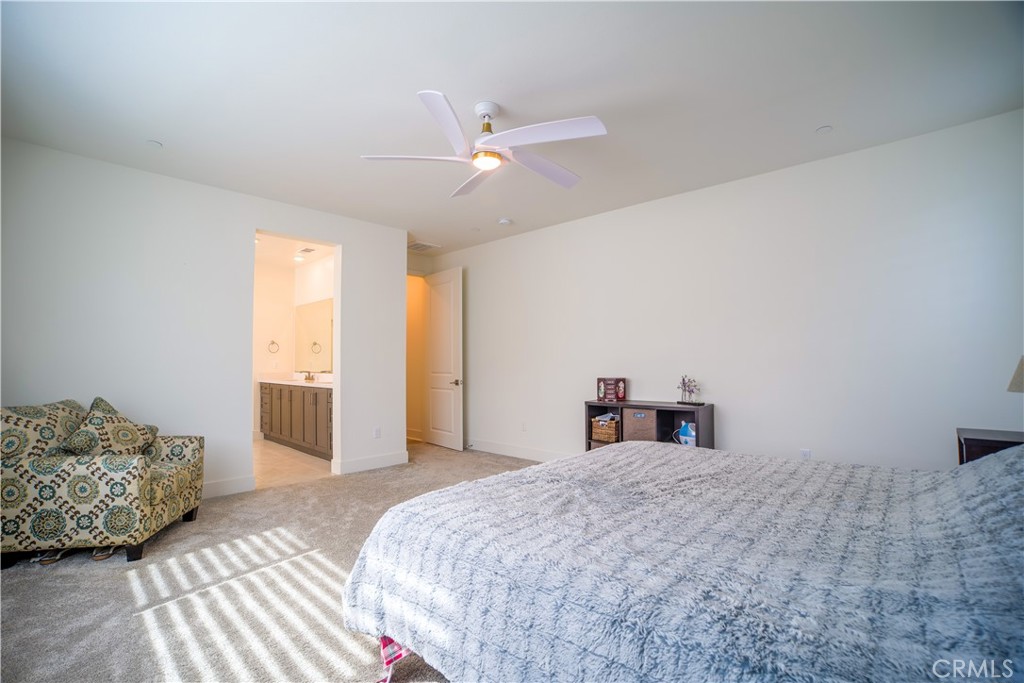 35323 Orchard Trail Fallbrook, CA 92028 - Photo 15 of 32 a bedroom with a large bed and a chandelier