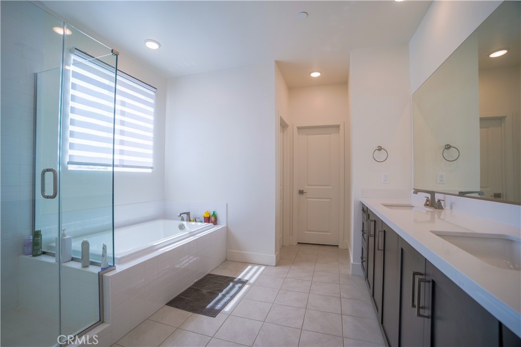 35323 Orchard Trail Fallbrook, CA 92028 - Photo 17 of 32 a bathroom with a tub sink and mirror