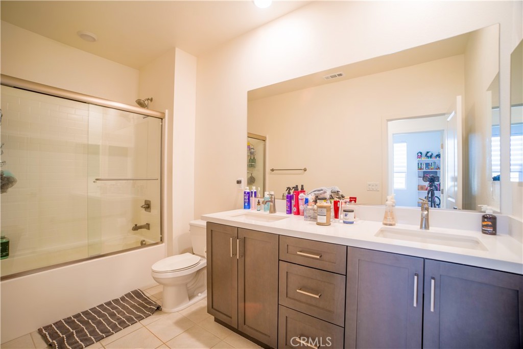 35323 Orchard Trail Fallbrook, CA 92028 - Photo 20 of 32 a bathroom with a sink toilet vanity and shower