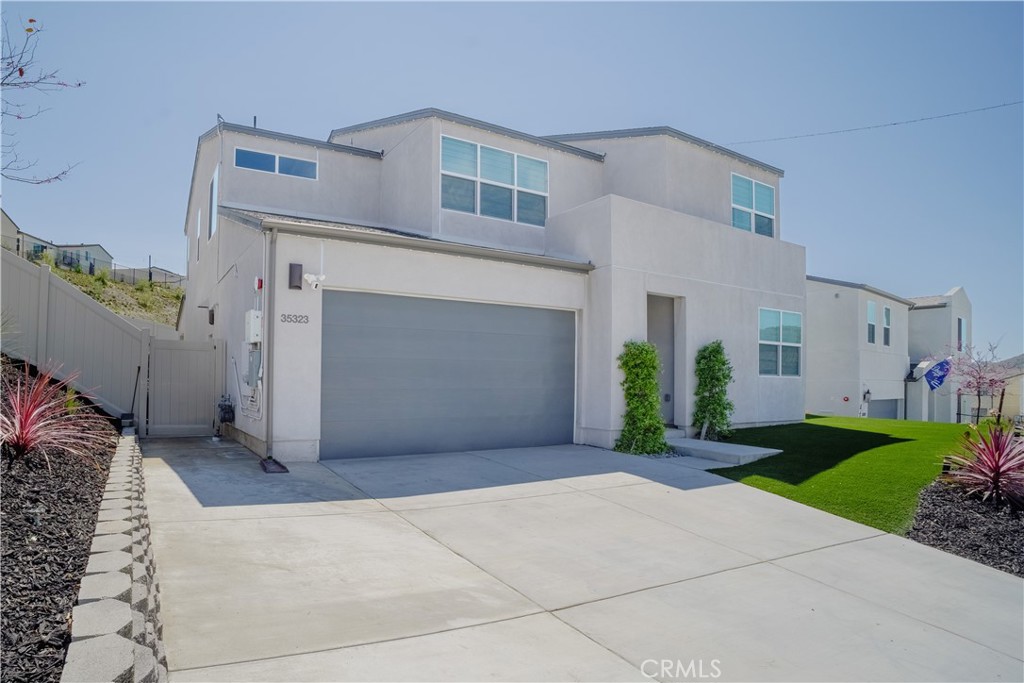 35323 Orchard Trail Fallbrook, CA 92028 - Photo 3 of 32 a view of a house with a yard and garage