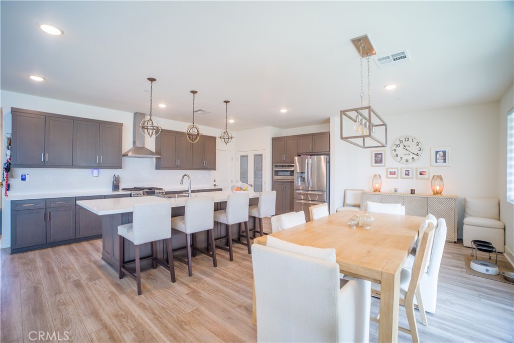 35323 Orchard Trail Fallbrook, CA 92028 - Photo 7 of 32 a large kitchen with a table and chairs
