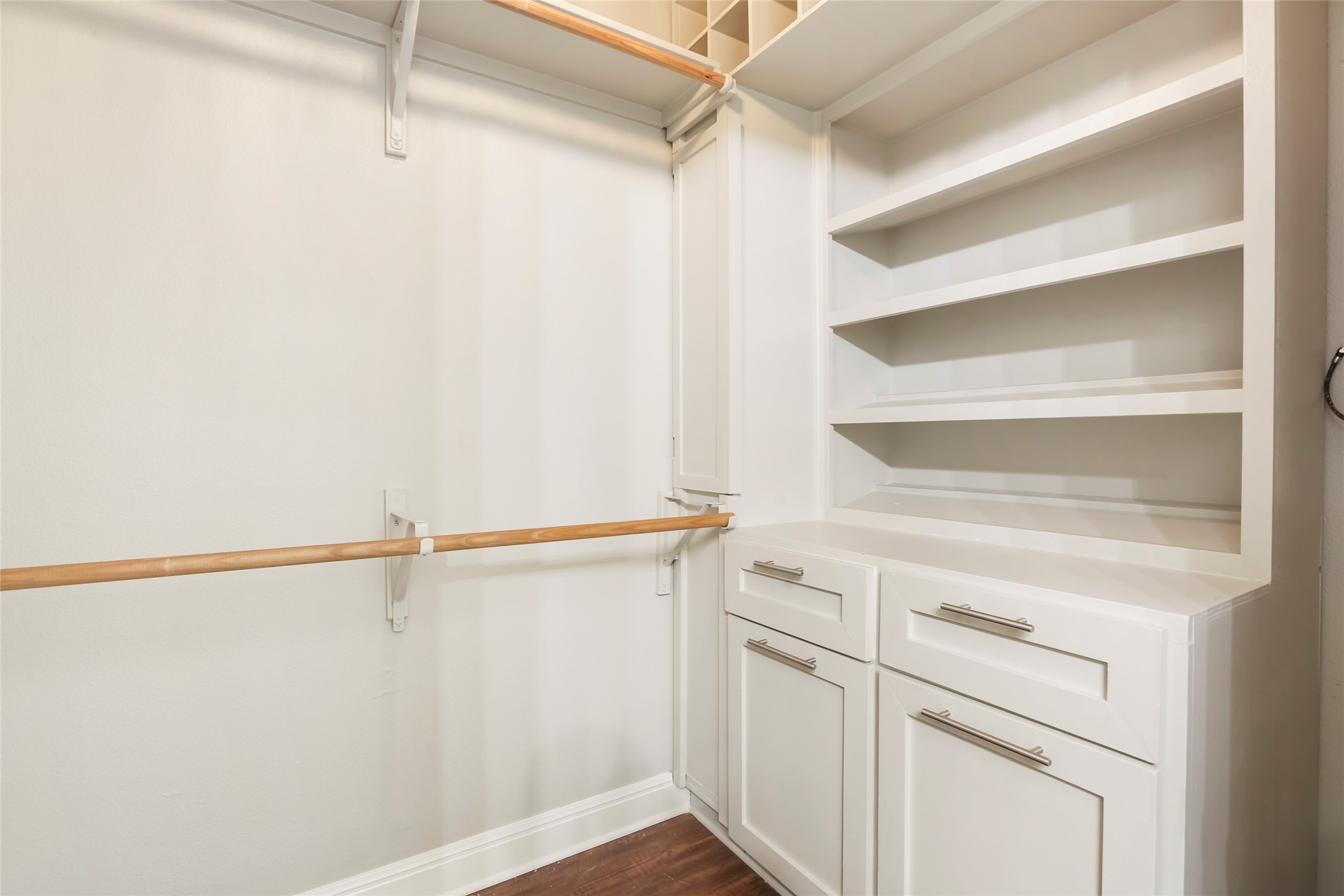3406 Menchaca Road, Unit 19 Austin, TX 78704 - Photo 25 of 25 Custom built-in shelving and ample hanging rods maximize organization in this closet.