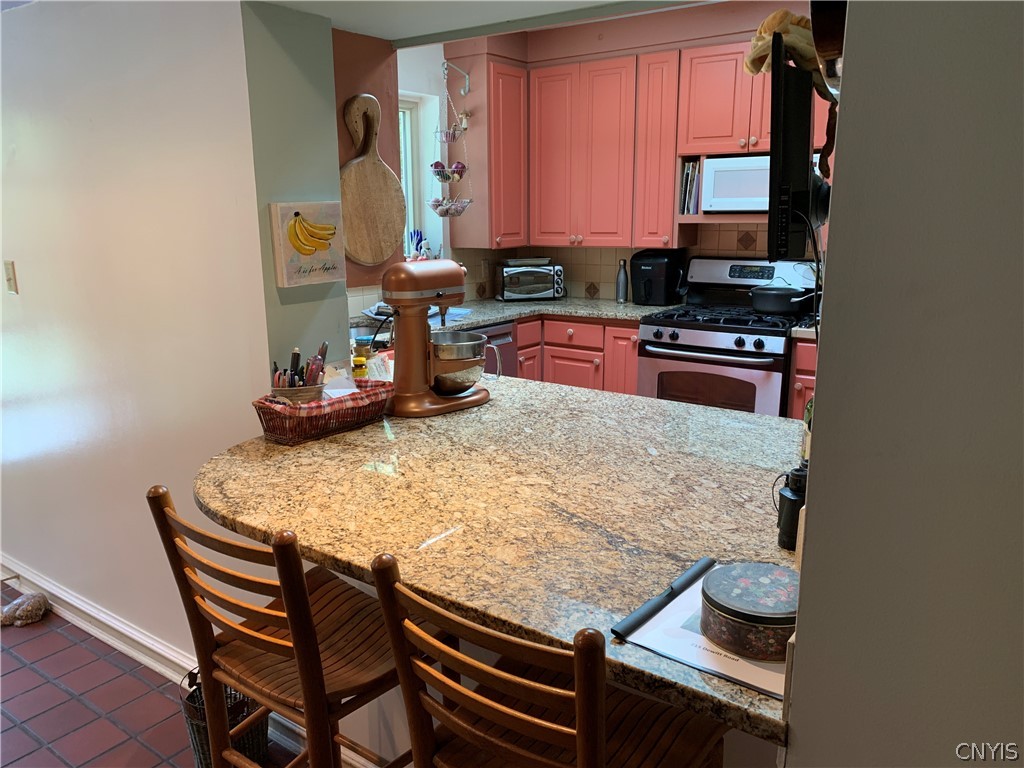 215 Dewitt Road Syracuse, NY 13214 - Photo 13 of 49 Granite counters extend to create a snack bar