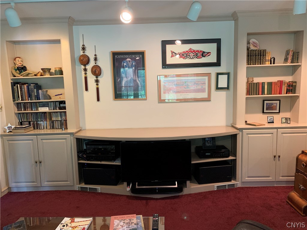 215 Dewitt Road Syracuse, NY 13214 - Photo 17 of 49 This family room wall has book cases and a media c