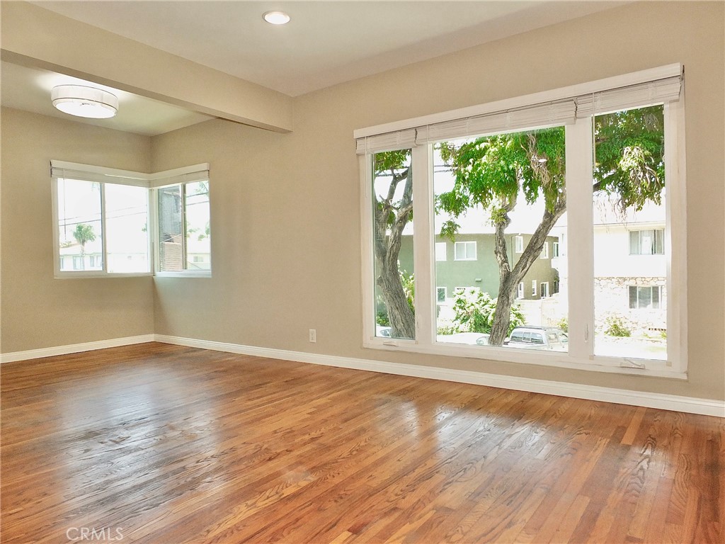 1808 East Appleton Street, Unit 7 Long Beach, CA 90802 - Photo 13 of 44 a view of an empty room with wooden floor and a window