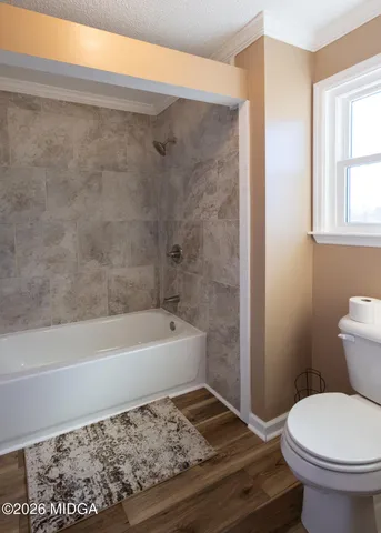a bathroom with a sink a toilet and bathtub
