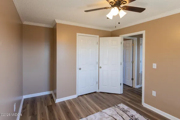 a view of an empty room with wooden floor