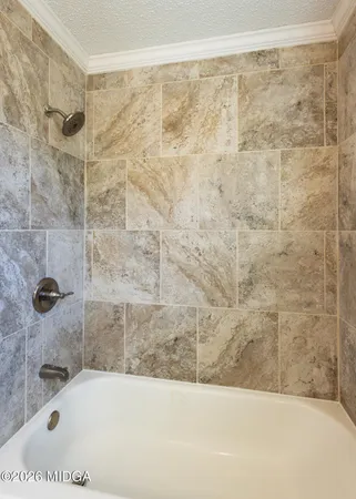 a bathroom with a bathtub and shower