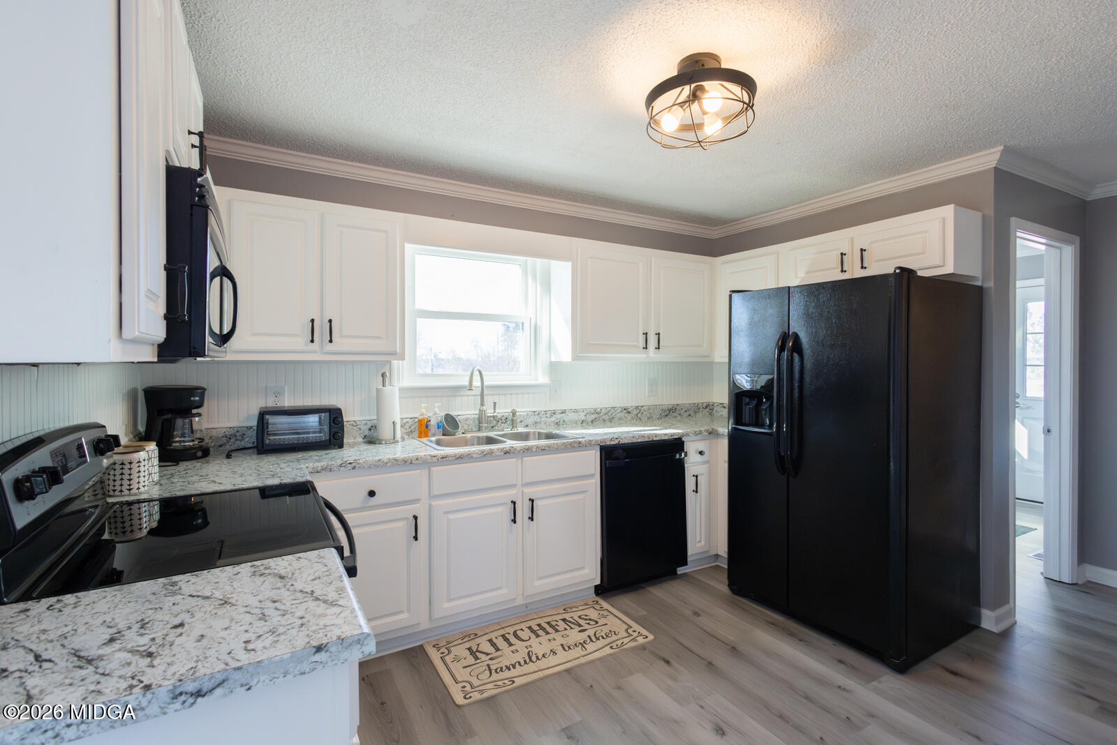 1578 Edsel Senn Road Rockledge, GA 30454 - Photo 5 of 32 a kitchen with a refrigerator sink and cabinets