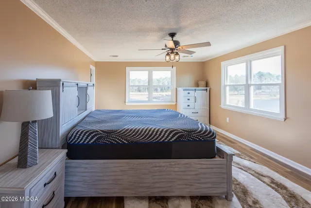 a spacious bedroom with a bed and a window
