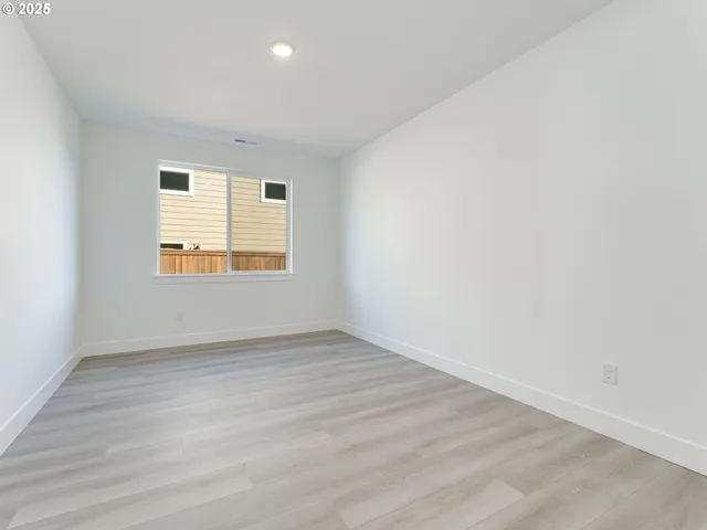 a view of an empty room and wooden floor
