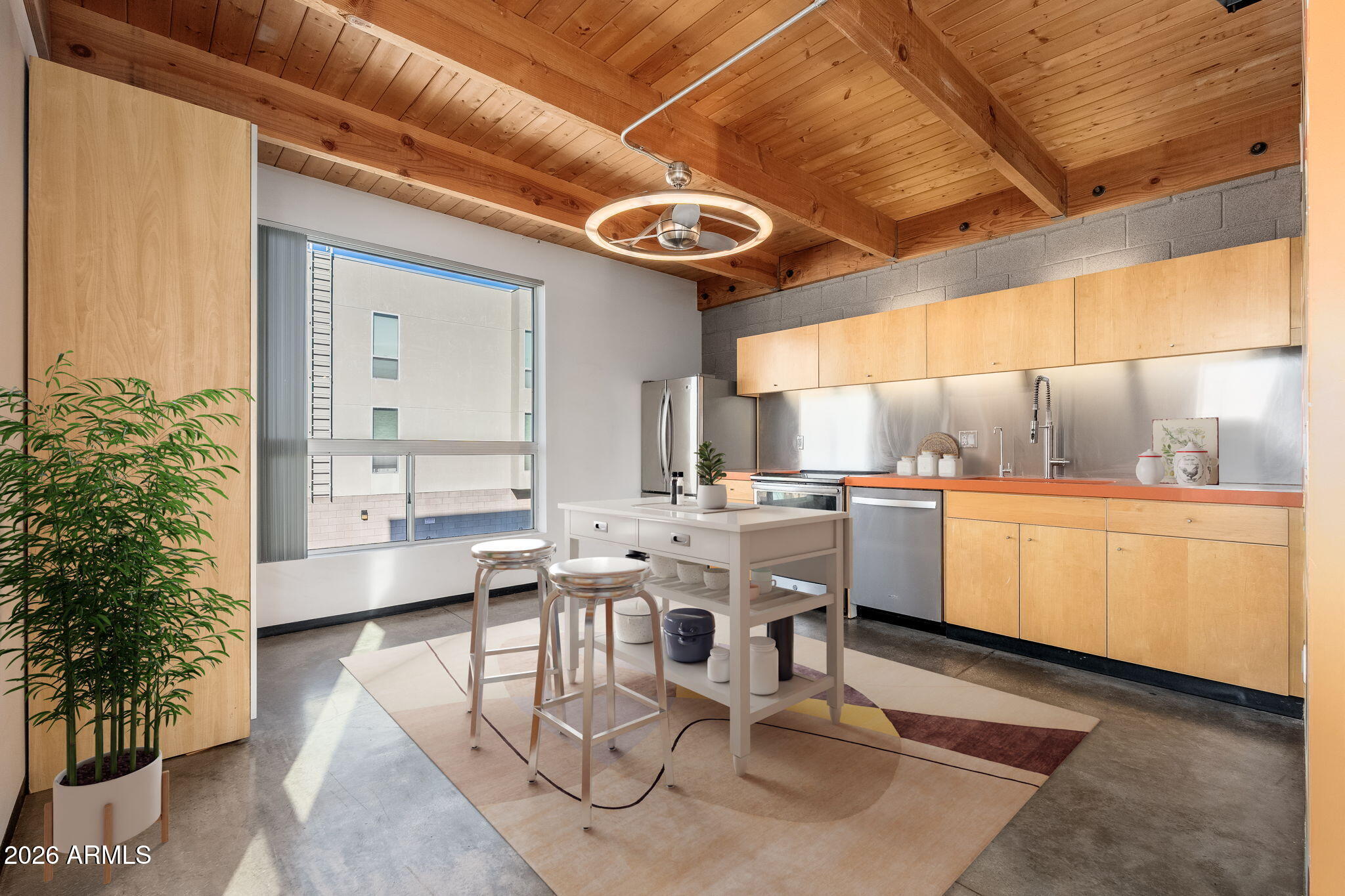 727 East Portland Street, Unit 6 Phoenix, AZ 85006 - Photo 2 of 31 a kitchen with a table chairs and a window