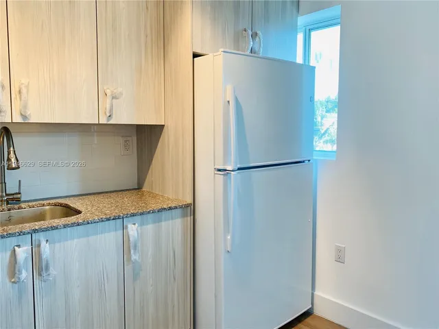 a white refrigerator freezer sitting in a kitchen