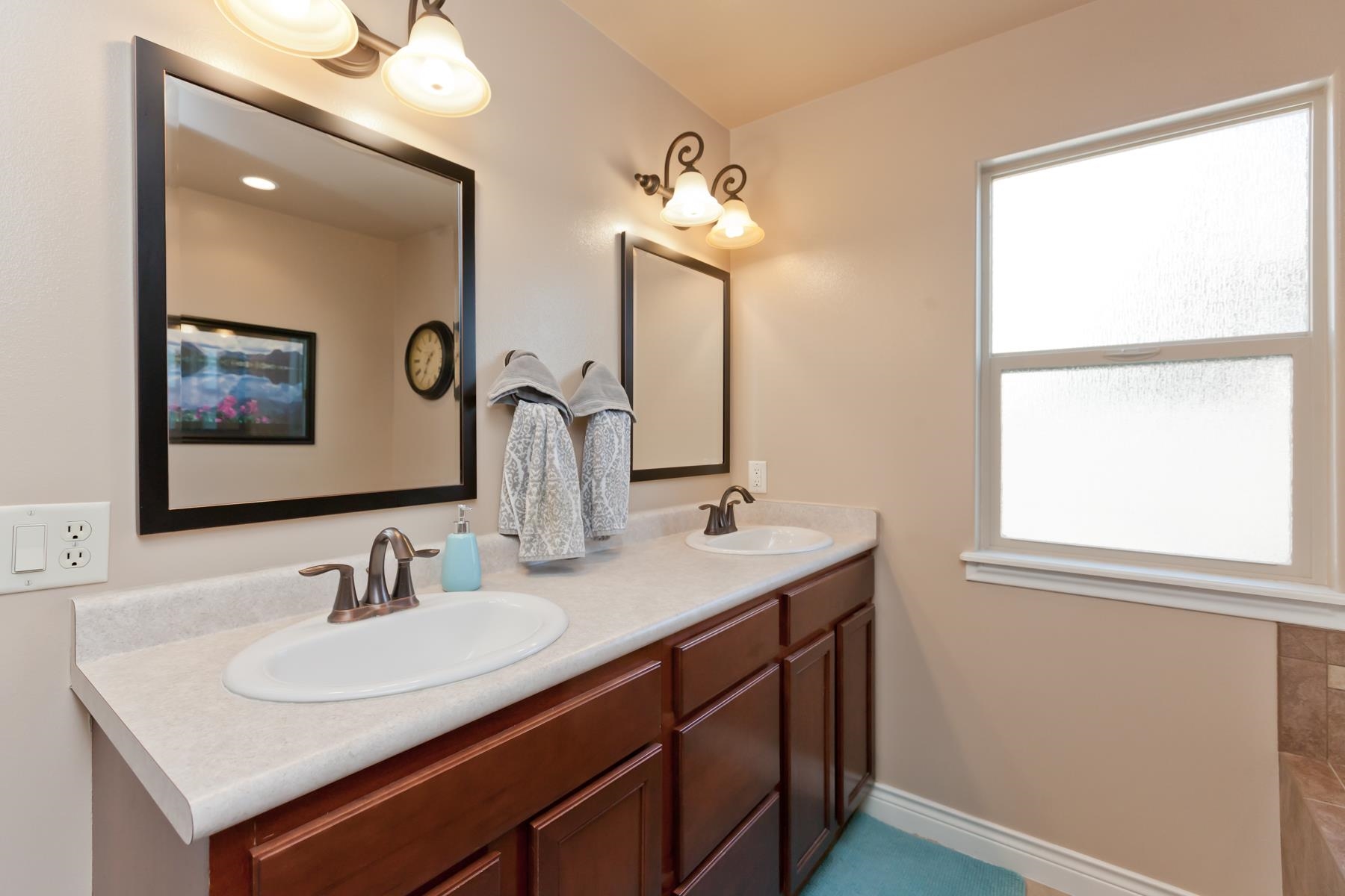 1037 Wingate Drive Fruita, CO 81521 - Photo 12 of 42 a bathroom with a double vanity sink and a mirror