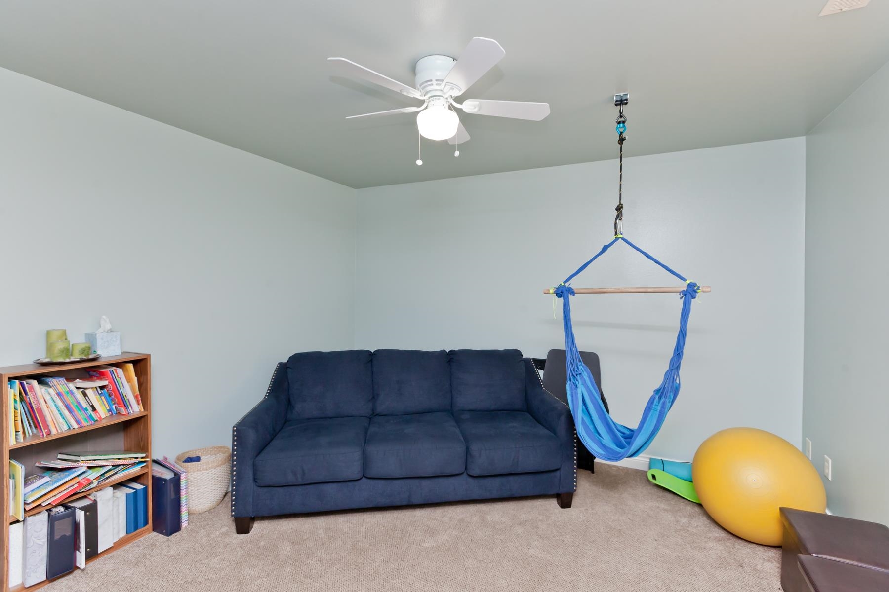 1037 Wingate Drive Fruita, CO 81521 - Photo 18 of 42 a living room with furniture a couch and a chandelier