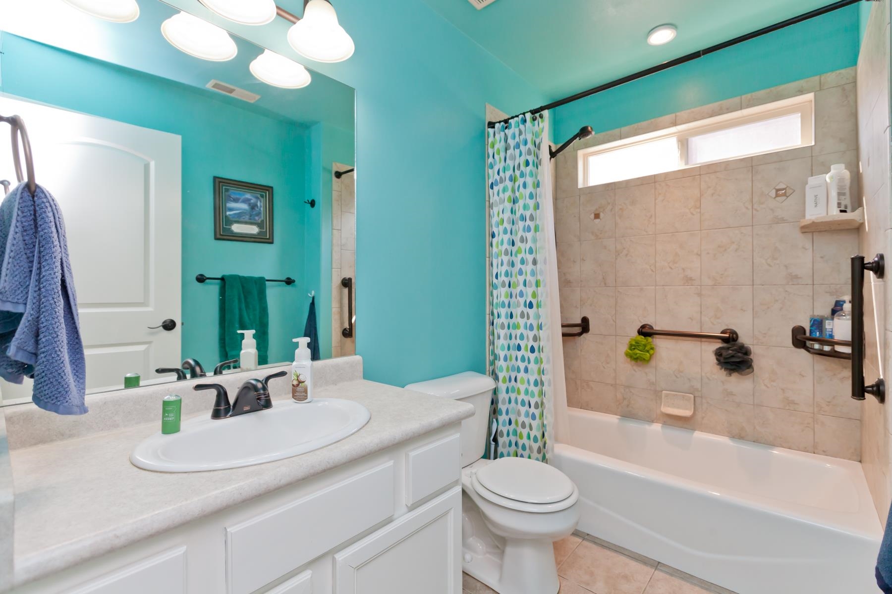 1037 Wingate Drive Fruita, CO 81521 - Photo 19 of 42 a bathroom with a granite countertop sink toilet a mirror a bathtub and shower