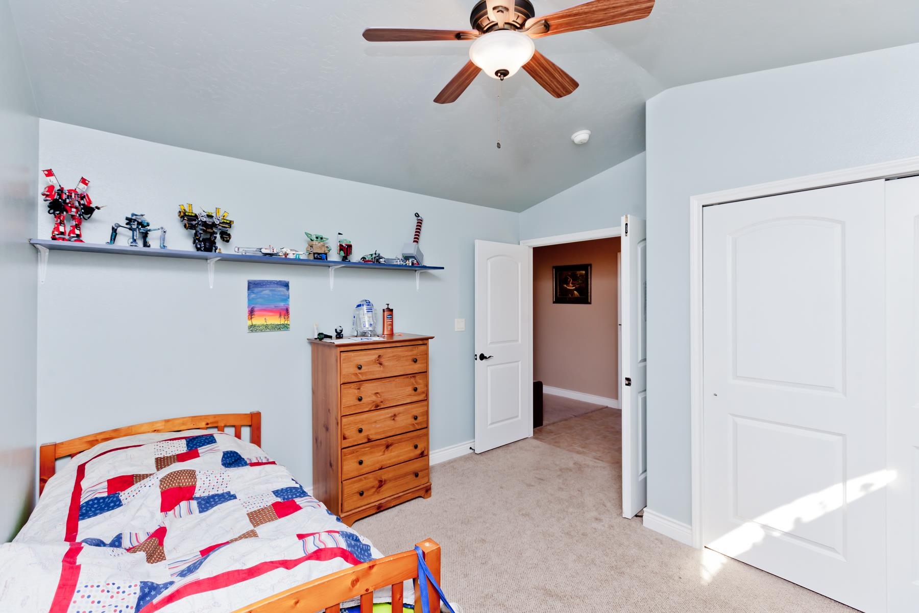1037 Wingate Drive Fruita, CO 81521 - Photo 25 of 42 a bedroom with baby bed and cabinets