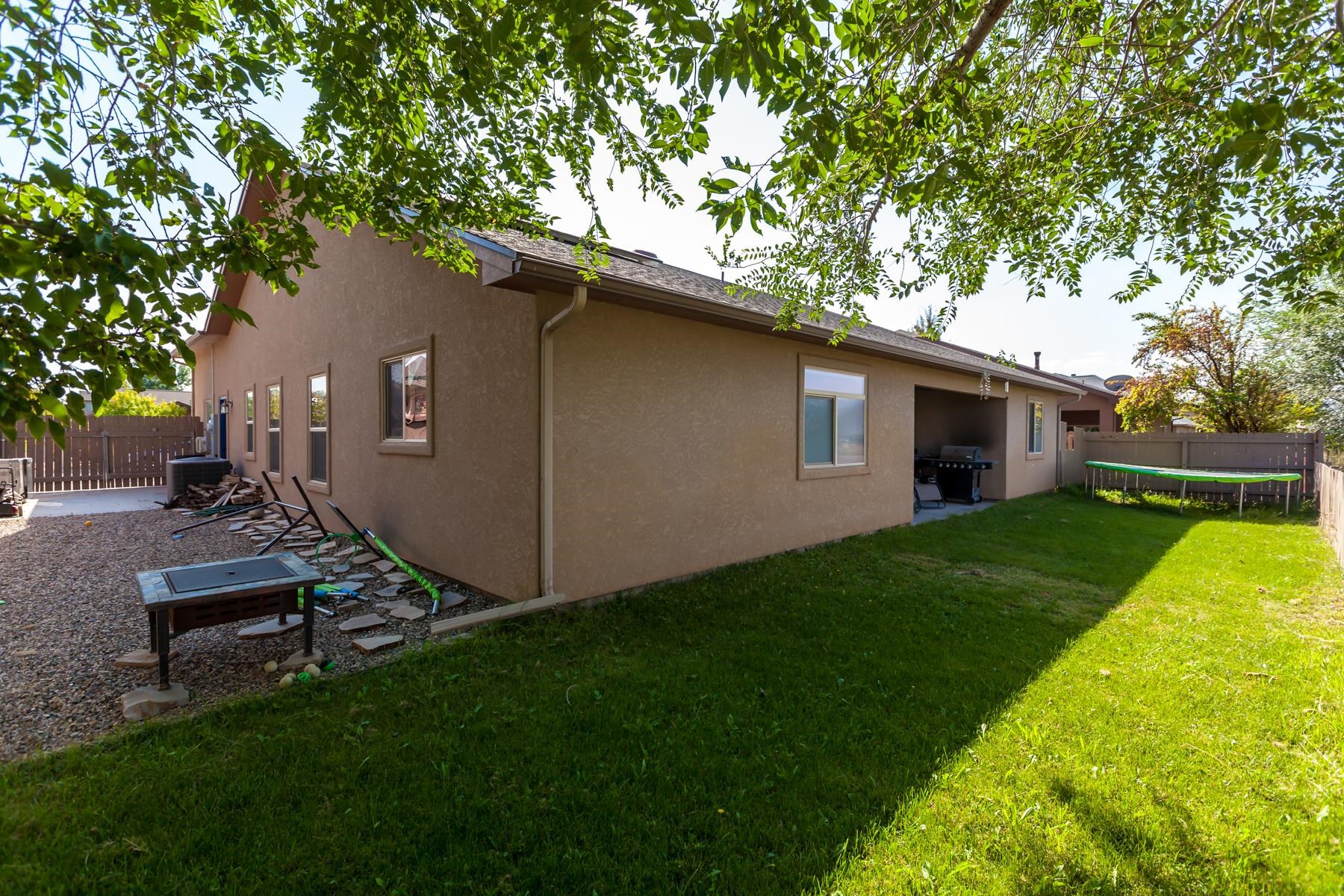 1037 Wingate Drive Fruita, CO 81521 - Photo 37 of 42 a view of backyard of house with outdoor seating and green space