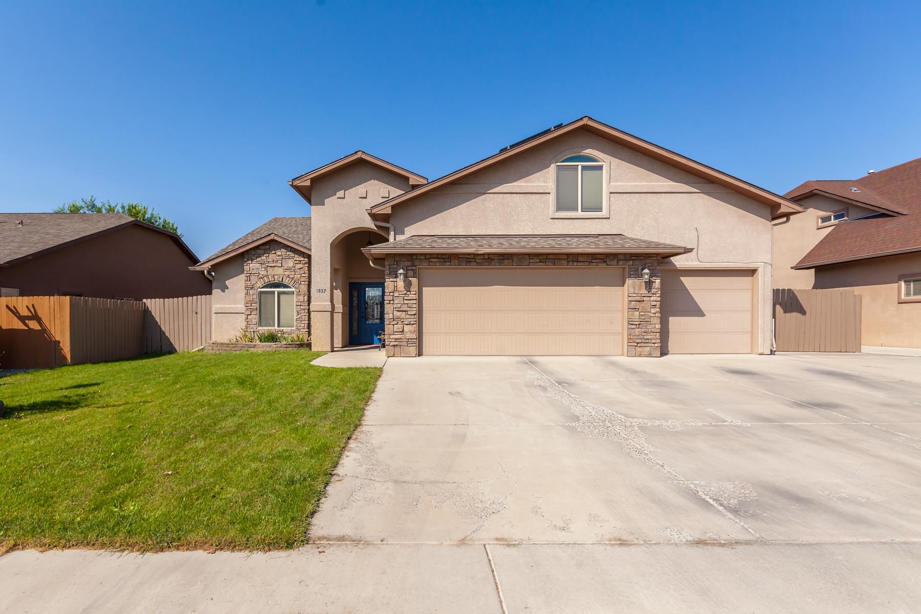 1037 Wingate Drive Fruita, CO 81521 - Photo 42 of 42 a front view of a house with a yard and garage