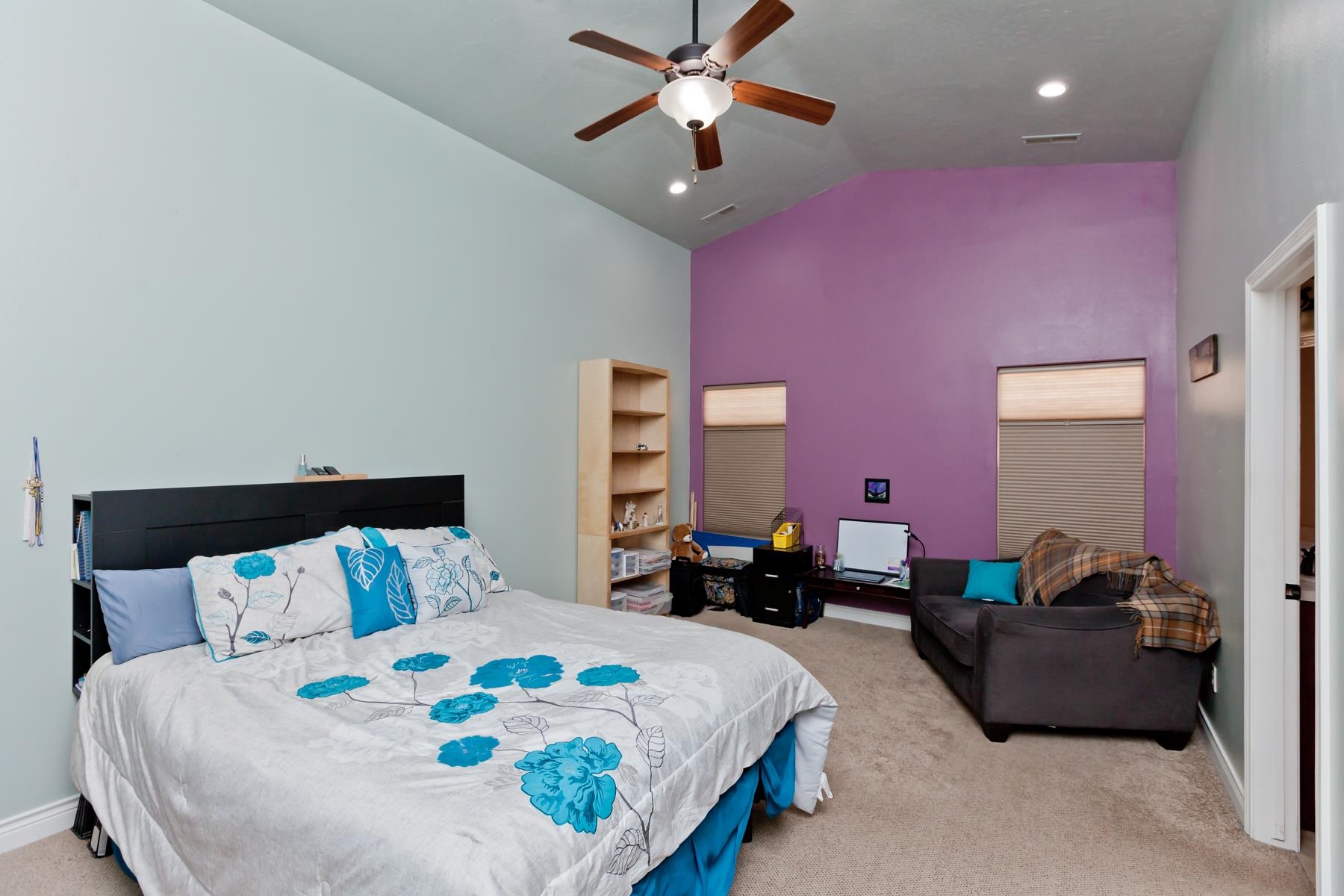 1037 Wingate Drive Fruita, CO 81521 - Photo 9 of 42 a bedroom with bed and a chandelier