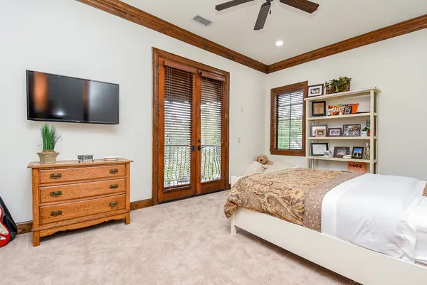a spacious bedroom with a bed and a large mirror