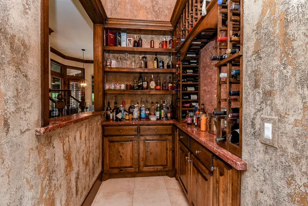 a bathroom with a granite countertop sink and a window