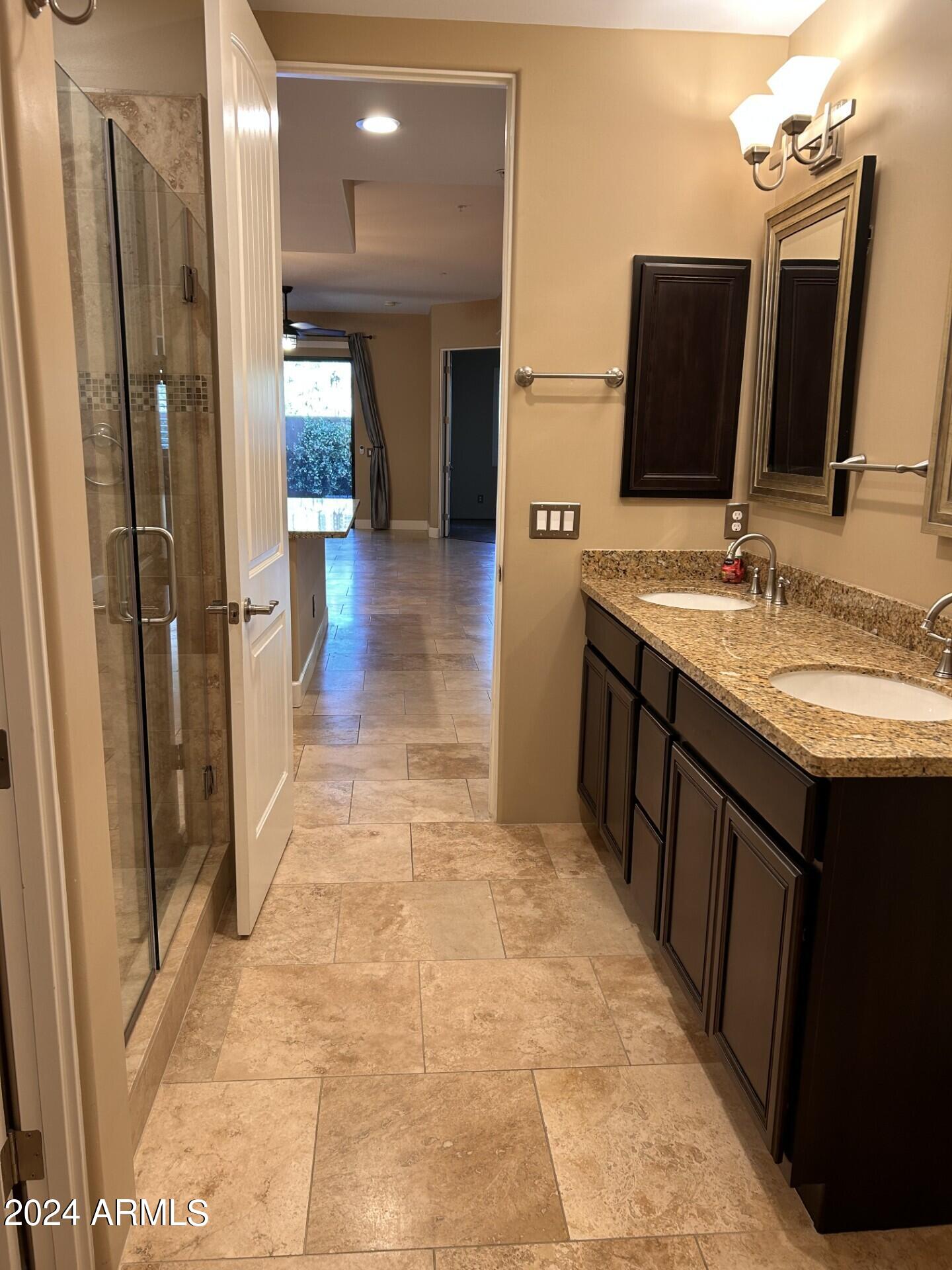 36600 North Cave Creek Road, Unit C20 Cave Creek, AZ 85331 - Photo 20 of 32 a bathroom with a double vanity sink and a mirror