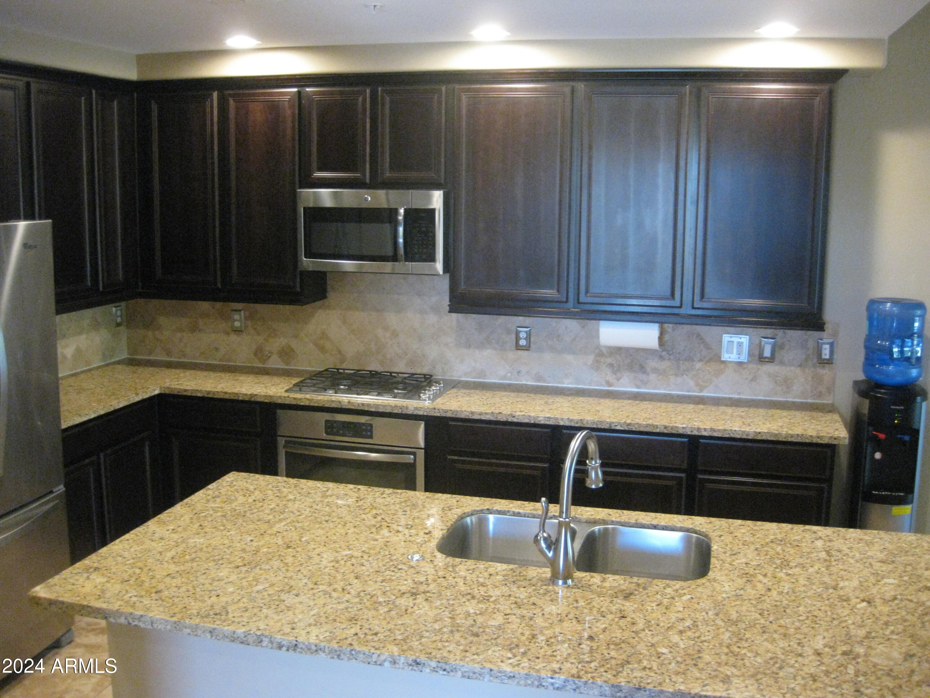36600 North Cave Creek Road, Unit C20 Cave Creek, AZ 85331 - Photo 4 of 32 a kitchen with granite countertop a refrigerator and a sink