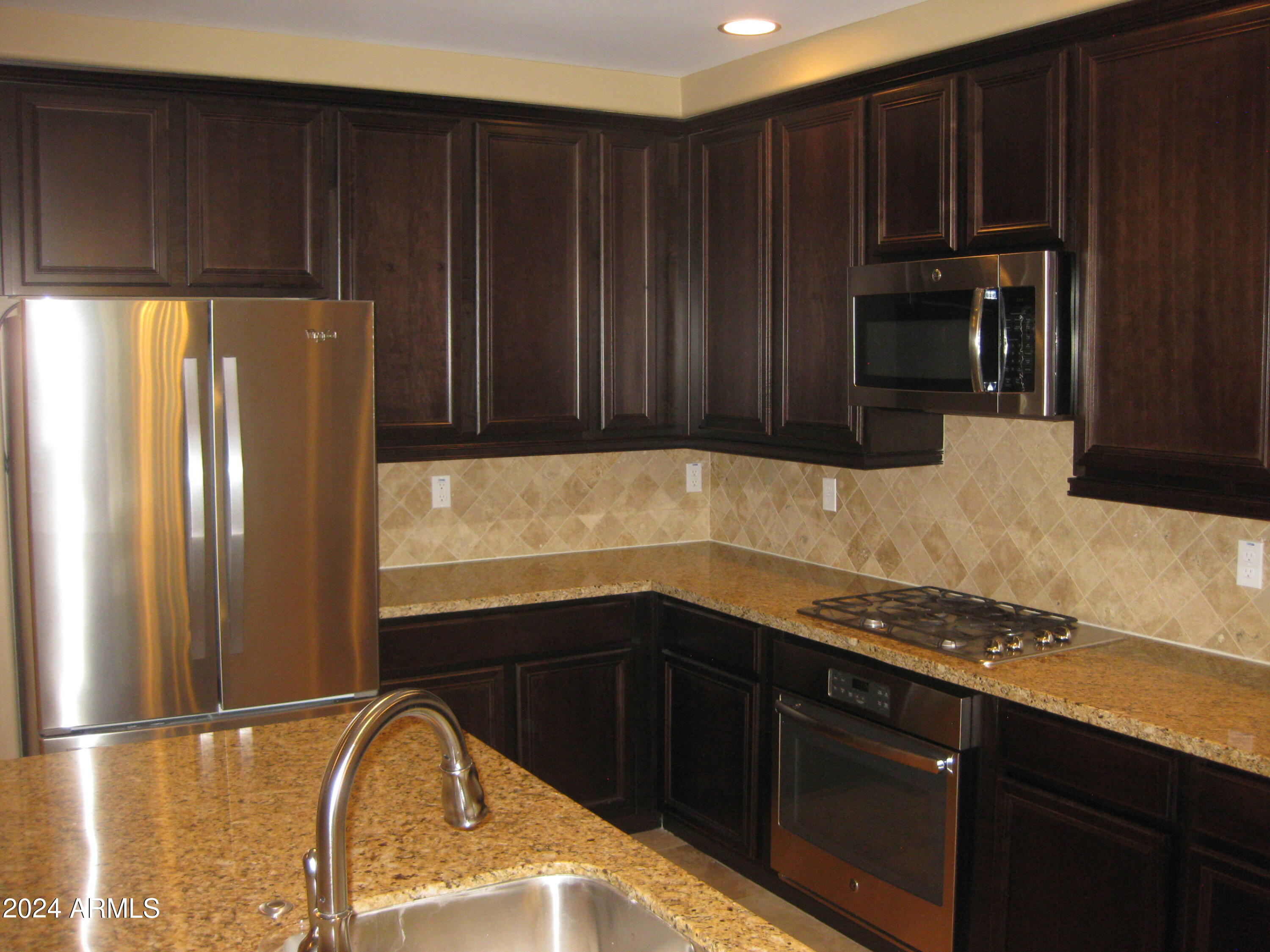 36600 North Cave Creek Road, Unit C20 Cave Creek, AZ 85331 - Photo 5 of 32 a kitchen with wooden cabinets and a sink