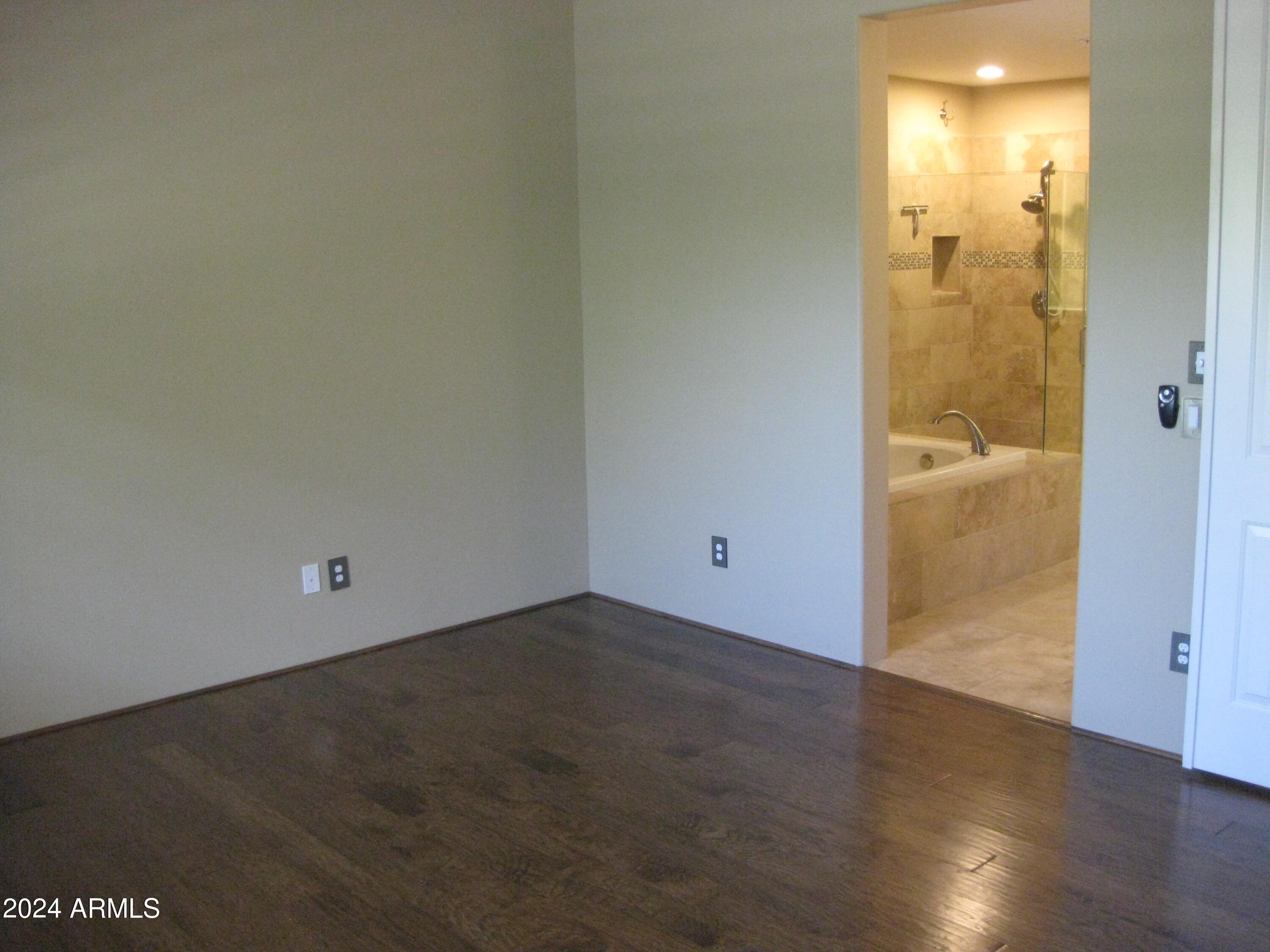 36600 North Cave Creek Road, Unit C20 Cave Creek, AZ 85331 - Photo 10 of 32 an empty room with wooden floor and mirror