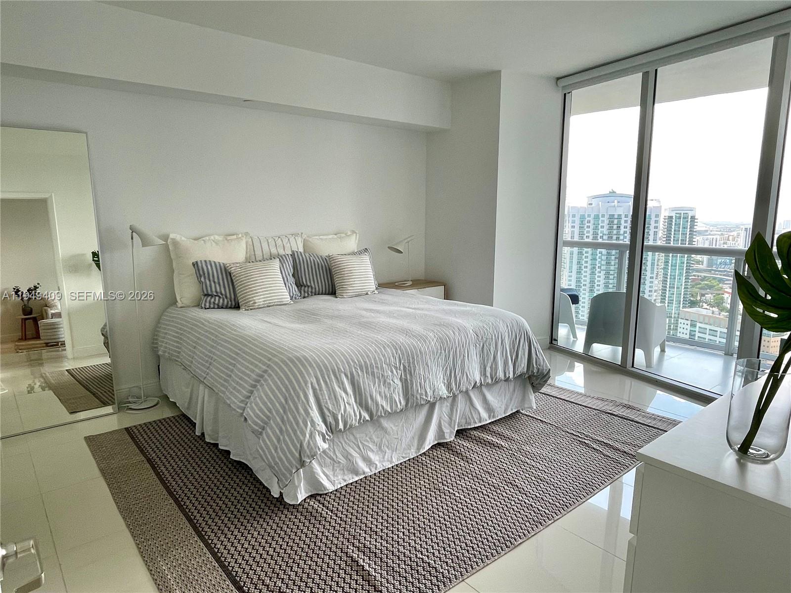 465 Brickell Avenue, Unit 4006 Miami, FL 33131 - Photo 11 of 25 a bedroom with double bed and a large window