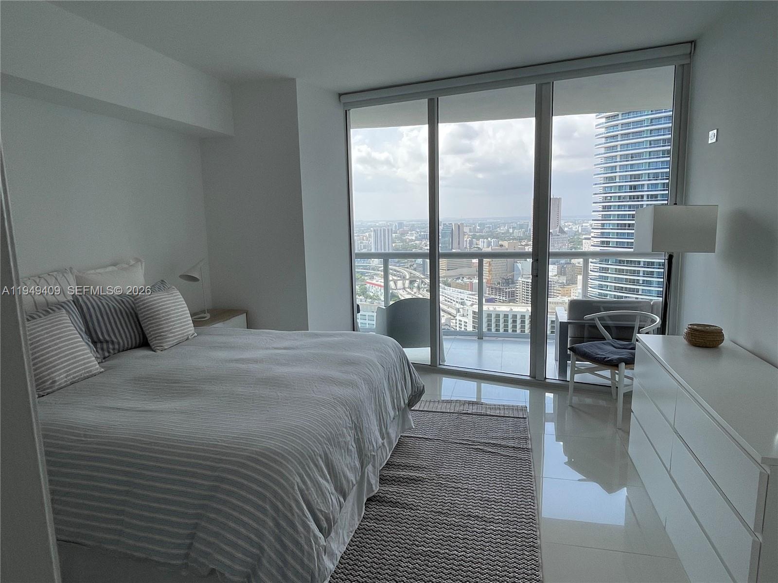 465 Brickell Avenue, Unit 4006 Miami, FL 33131 - Photo 12 of 25 a bedroom with a bed and a large window